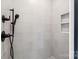 Modern shower featuring sleek tile work, shower head, and built-in shelving at 5526 Brookwood Ln, Hickory, NC 28602
