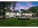 The backyard features a deck, outdoor kitchen, firepit area, and lush landscaping at 5533 Murrayhill Rd, Charlotte, NC 28210