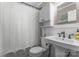 Traditional bathroom featuring a shower with a curtain, vanity, and white wooden cabinets at 5533 Murrayhill Rd, Charlotte, NC 28210
