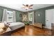Comfortable bedroom with hardwood floors, neutral decor, and plenty of natural light at 5533 Murrayhill Rd, Charlotte, NC 28210