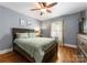 Serene bedroom featuring hardwood floors, ample natural light, and a comfortable queen-sized bed at 5533 Murrayhill Rd, Charlotte, NC 28210