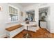 Cozy breakfast nook with a built-in bench, white marble table, and natural light at 5533 Murrayhill Rd, Charlotte, NC 28210