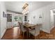 Elegant dining room with hardwood floors, stylish lighting, and French doors to the outside at 5533 Murrayhill Rd, Charlotte, NC 28210