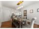 Bright dining room features hardwood floors, contemporary lighting, and a view of the kitchen at 5533 Murrayhill Rd, Charlotte, NC 28210
