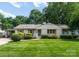 Charming single-story home with landscaped yard, carport, and inviting front entrance at 5533 Murrayhill Rd, Charlotte, NC 28210