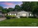 Charming home with beautiful landscaping, manicured lawn, white brick, and lovely curb appeal at 5533 Murrayhill Rd, Charlotte, NC 28210