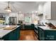 Modern kitchen features an island, stainless steel appliances, white subway tiles, and sleek cabinetry at 5533 Murrayhill Rd, Charlotte, NC 28210