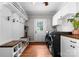 Bright laundry room features washer/dryer, storage, hanging hooks, and an exterior door at 5533 Murrayhill Rd, Charlotte, NC 28210