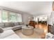 Inviting living room with large windows, hardwood floors, and an open layout that flows into the kitchen at 5533 Murrayhill Rd, Charlotte, NC 28210