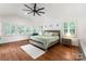 Spacious main bedroom boasting large windows, plantation shutters, vaulted ceiling, and hardwood floors at 5533 Murrayhill Rd, Charlotte, NC 28210