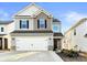 Charming two-story home with a two-car garage and a mix of siding and stone accents at 5775 Soft Shell Dr # 310, Lancaster, SC 29720