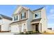 Well-maintained two-story home featuring a two-car garage and landscaped front yard at 5775 Soft Shell Dr # 310, Lancaster, SC 29720