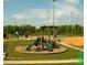 Community playground features slides and equipment, set in well-maintained green space with sports fields beyond at 5775 Soft Shell Dr # 310, Lancaster, SC 29720