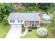 An aerial view of a charming house with a backyard pool and a lush green lawn at 5909 Ryder Ave, Charlotte, NC 28226