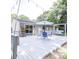 Backyard deck features a dining table, a porch swing, and string lights at 5909 Ryder Ave, Charlotte, NC 28226