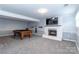 Finished basement with a pool table, a fireplace and gray carpet at 5909 Ryder Ave, Charlotte, NC 28226