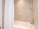 Tiled bathtub features a shower with a handheld shower head and tile walls at 5909 Ryder Ave, Charlotte, NC 28226