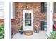 Close-up of a welcoming front entrance framed by brickwork and decorative lanterns at 5909 Ryder Ave, Charlotte, NC 28226