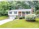Attractive two-story brick home with an attached garage and a manicured lawn at 5909 Ryder Ave, Charlotte, NC 28226