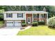 Charming brick and vinyl home with a well-manicured lawn and an attached two-car garage at 5909 Ryder Ave, Charlotte, NC 28226
