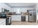 This sleek kitchen is equipped with stainless steel appliances and white cabinets at 5909 Ryder Ave, Charlotte, NC 28226