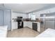 Modern kitchen with white cabinets, stainless steel appliances, and tile flooring at 5909 Ryder Ave, Charlotte, NC 28226