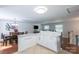 Bright, open kitchen and dining area with ample counter space, sleek white cabinetry and hardwood floors at 5909 Ryder Ave, Charlotte, NC 28226