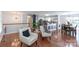 Open-concept living room with hardwood floors, white walls, and a view into the modern kitchen and dining area at 5909 Ryder Ave, Charlotte, NC 28226
