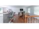 Open-concept living area with a hardwood floor, white walls, and bright, natural light at 5909 Ryder Ave, Charlotte, NC 28226