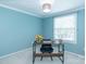 Well-lit home office with blue walls, a wooden desk, and a bright window at 5909 Ryder Ave, Charlotte, NC 28226