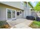 Back patio with sliding doors, a storage area, a grill, and a partially fenced yard at 6044 Heath Valley Rd, Charlotte, NC 28210