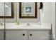 Bathroom featuring a white vanity, framed mirrors, and neutral decor at 6044 Heath Valley Rd, Charlotte, NC 28210