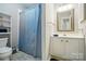 Bathroom with shower, sink, vanity, mirror, and storage, offering a practical and clean space at 6044 Heath Valley Rd, Charlotte, NC 28210