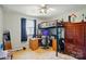 A quirky bedroom featuring a lofted bed over a desk, with carpet, a ceiling fan, and a window at 6044 Heath Valley Rd, Charlotte, NC 28210