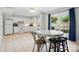Bright kitchen with white cabinets, tile floors, breakfast table and view to the backyard at 6044 Heath Valley Rd, Charlotte, NC 28210