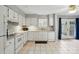 Bright kitchen leading to outdoor access with tile flooring and ample cabinets at 6044 Heath Valley Rd, Charlotte, NC 28210