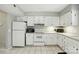 Well-lit kitchen offering ample cabinet space, tile floors and essential appliances at 6044 Heath Valley Rd, Charlotte, NC 28210