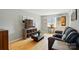 Comfortable living room featuring wood floors, neutral walls, a plush gray couch, and ample natural light at 6044 Heath Valley Rd, Charlotte, NC 28210