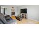 Inviting living room with wood floors, a gray sofa, modern shelving, and stylish decor at 6044 Heath Valley Rd, Charlotte, NC 28210