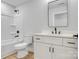 Modern bathroom features tub shower, black hardware and vanity with stone countertop at 707 W Davidson Ave, Gastonia, NC 28052