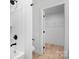 Bathroom featuring a shower and an open doorway to a closet with wire shelves at 707 W Davidson Ave, Gastonia, NC 28052