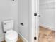 Bathroom featuring a toilet, towel rack and a closet with wire shelving at 707 W Davidson Ave, Gastonia, NC 28052
