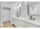 Modern bathroom with double vanity, quartz countertops, and black hardware at 707 W Davidson Ave, Gastonia, NC 28052