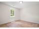 Bright bedroom with hardwood floors and a window view of the greenery outside at 707 W Davidson Ave, Gastonia, NC 28052