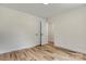 A bedroom with light hardwood floors and a white closet with black hardware at 707 W Davidson Ave, Gastonia, NC 28052