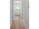 Hallway with wood look floors and modern trim leads to various rooms of this charming home at 707 W Davidson Ave, Gastonia, NC 28052