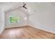 Bright living area with vaulted ceilings, modern flooring, and natural light from a large window at 707 W Davidson Ave, Gastonia, NC 28052