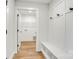 Hallway/mudroom with coat hooks, bench, and doorway to a closet with wire racks at 707 W Davidson Ave, Gastonia, NC 28052