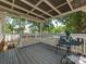 Relax on this covered back porch with stylish outdoor furniture and view of the lawn at 713 Springfield Nw Dr, Concord, NC 28027