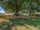 Expansive backyard with mature trees and a white privacy fence, offering plenty of space at 713 Springfield Nw Dr, Concord, NC 28027